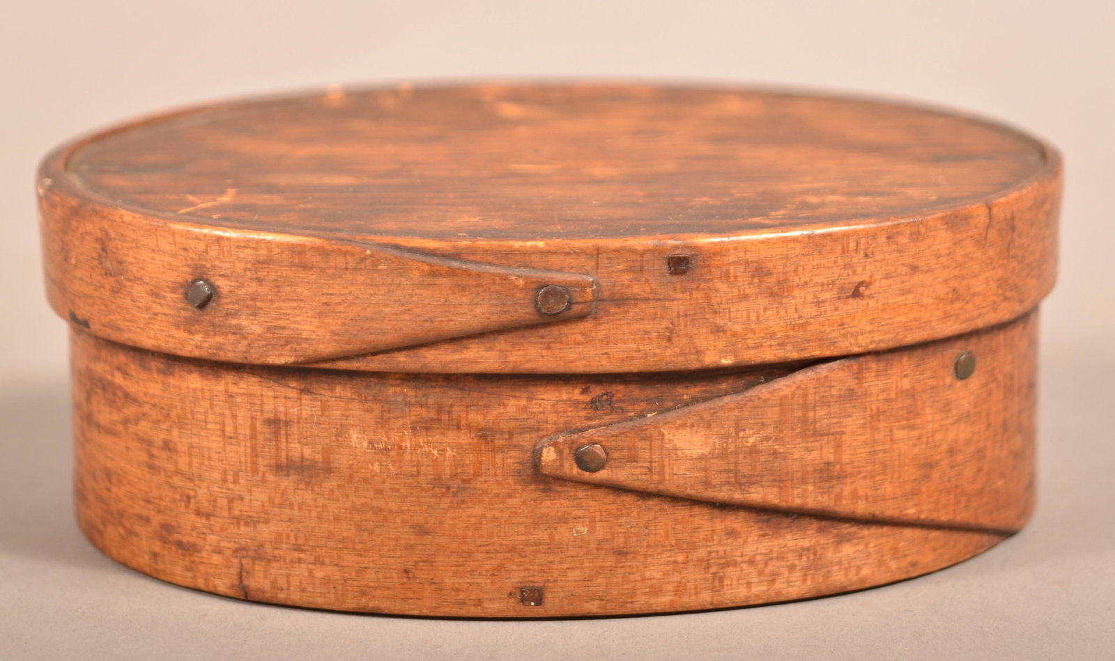 Small 19th Century Oval Bentwood Pantry Box.: Small 19th Century Oval Bentwood Pantry Box. Lapped finger joints supported by copper tacks. 1-5/8"h. x 4-3/4"w x 3-1/2"d. Condition: Good with wear and minor loss.