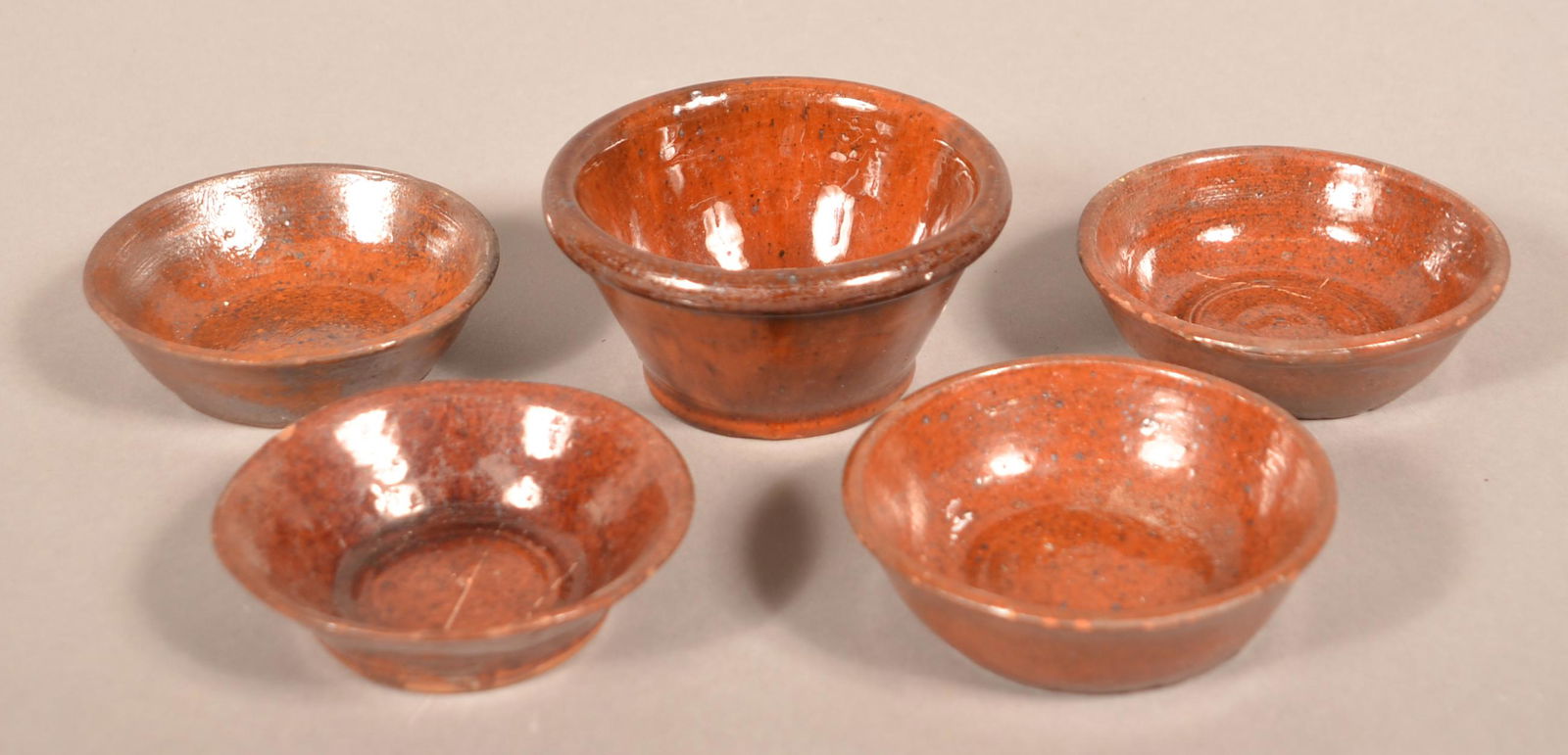 Five Glazed Redware Pottery Small Bowls.: Five Glazed Redware Pottery Small Bowls. Attributed to Medinger Pottery. Largest 3-7/8" diam. Condition: Good to very good one with rim chip.