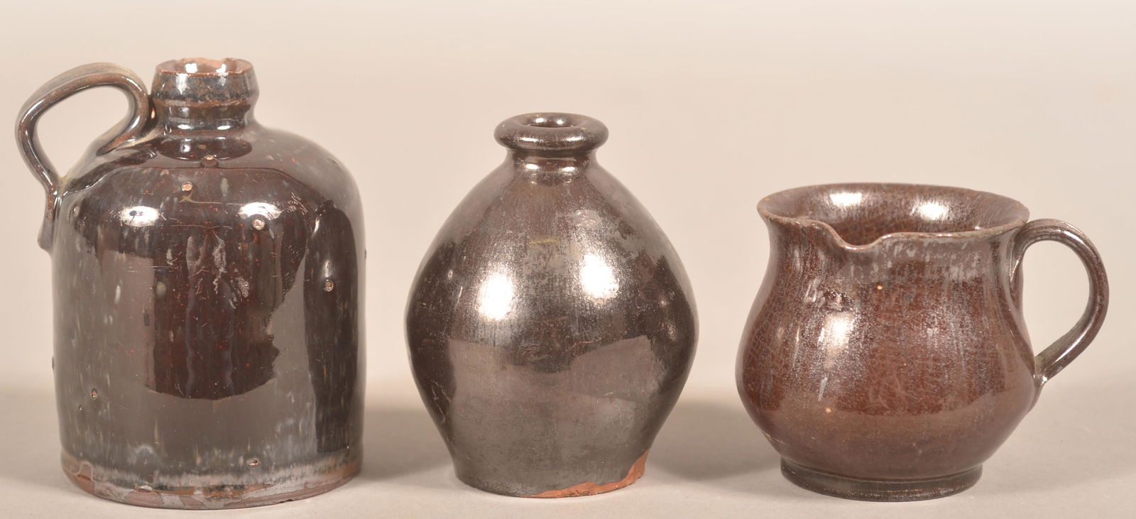 3 19th Century Manganese Glazed Redware Small Vessels.: Three 19th Century Manganese Glazed Redware Small Vessels. Jug, bottle and side spout cream pitcher. Tallest 4-3/4"h. Condition: Good with some chips.