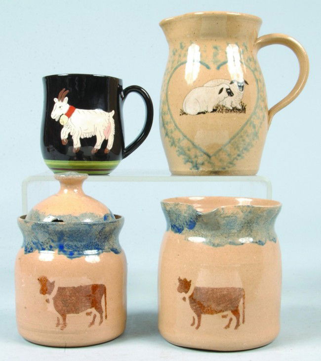 Four Pieces of Pottery: Cow decorated covered sugar: Four Pieces of Pottery: Cow decorated covered sugar bowl and cream pitcher by Mills Pottery, Goat and floral decorated mug marked Burkart Handarbeit A/p, Sheep decorated cream pitcher marked Nancy And