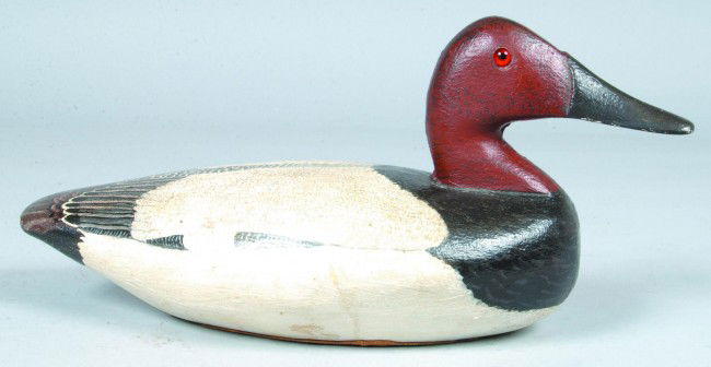 Cast Iron Canvasback Duck Decoy Doorstop, realisti: Cast Iron Canvasback Duck Decoy Doorstop, realistic painted with hollow body and glass eyes, signed on leather bottom J S Posey 1968, 7"h. Condition: Very good.