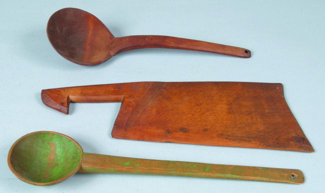 Three Various Pieces of Woodenwares: carved spoon : Three Various Pieces of Woodenwares: carved spoon painted green with hanging hole, 17" long, ladle with natural finish, 15" long and carved cleaver with natural finish, 17 1/2" l. Condition: All good.
