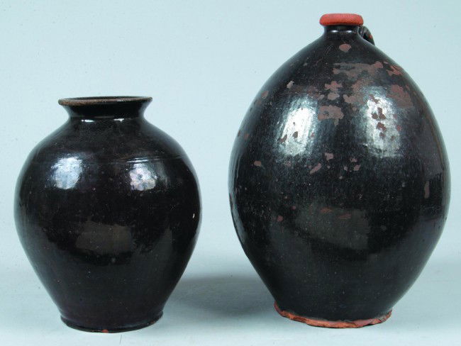 Redware Bulbous Form Vase and Jug, both with manga: Redware Bulbous Form Vase and Jug, both with manganese glaze, 10-1/4" Vase, Condition rim and base chips. 13-3/4"h Jug, Condition: Rim and base chips, pitting and hole on body.