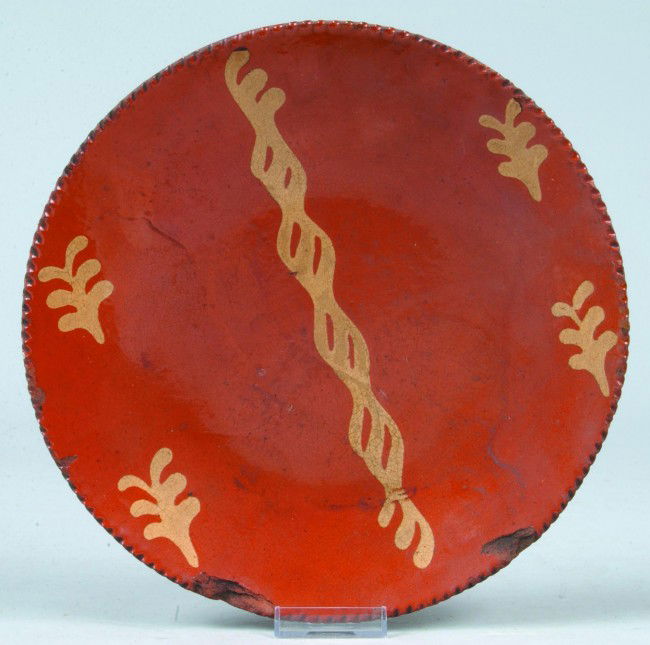 Redware Slip Decorated 10-5/8"Plate with yellow sl: Redware Slip Decorated 10-5/8"Plate with yellow slip intertwine lines and sprig decorated, Condition: Chips.