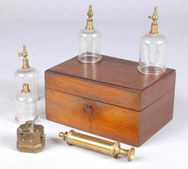 19th Century Cased Bleeder Set fitted in a mahogan: 19th Century Cased Bleeder Set fitted in a mahogany case. Brass ten blade bleeder, brass syringe and four various glass bleeder cups with brass valve attachments. Case measures 4"h x 8"w x 5 1/2"d. Co