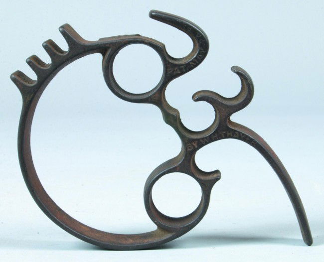 W. H. Thayer Cast Iron Universal Tool, Household: W. H. Thayer Cast Iron Universal Tool, Household combination tool has multiple applications as a holder for hot items in the kitchen, meat tenderizer and trivet signed W. H. Thayer and patent date May