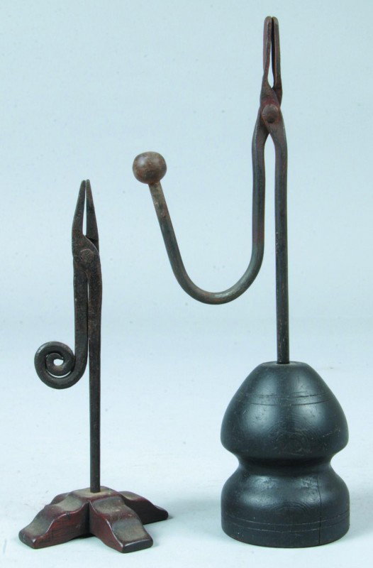 Two Wrought Iron Rush Holder Lamps with wooden bas: Two Wrought Iron Rush Holder Lamps with wooden bases, stepped x base and turned base,7 1/2"h.and 11"h. Condition: Good.