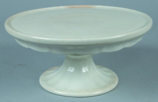 White Ironstone China Cake Stand with lower scallo: White Ironstone China Cake Stand with lower scalloped edge by Joseph Mayer & Co., (J.M.& Co.), with printed mark, 5-5/8"h. x 12"dia., Condition: Good with some discoloring.