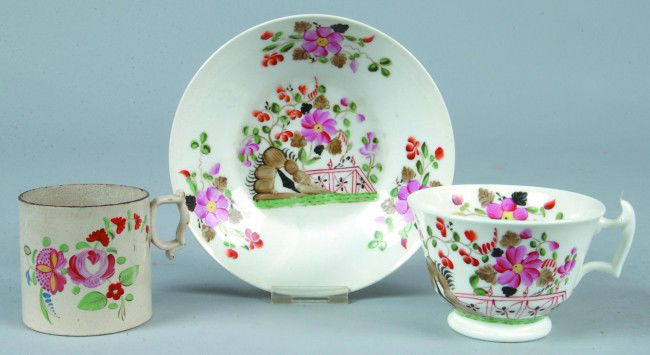 Ironstone Child's Mug and Porcelain China Tea Cup: Ironstone Child's Mug and Porcelain China Tea Cup and Saucer with hand painted floral decorations, mug 2-1/2"h., Condition: Good, mug with minor edge nips.