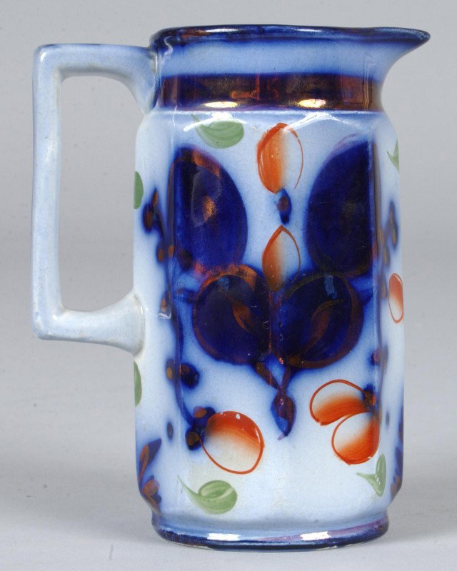 Gaudy Ironstone China Cream Pitcher with floral de: Gaudy Ironstone China Cream Pitcher with floral decorated with lustre highlights, paneled body, 5 1/2"h. Condition: Good.