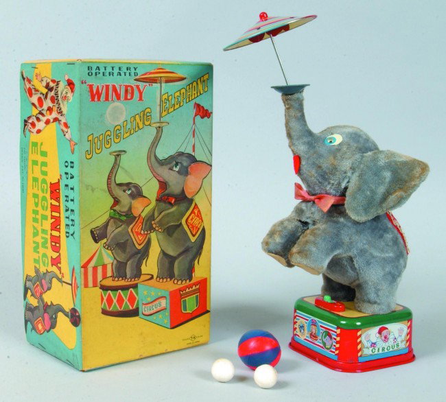 T.N. (Japan) Cloth Covered and Tin Lithograph "Wind: T.N. (Japan) Cloth Covered and Tin Lithograph "Windy" the Juggling Elephant Battery Operated Toy with original box. 9 1/2" high. Condition: Good.