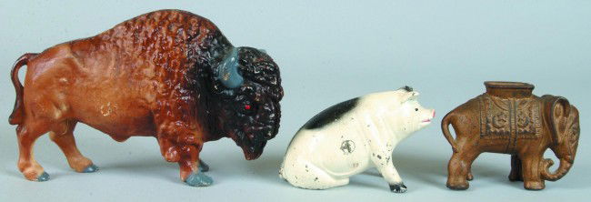 Three Various Cast Iron Animal Still Banks; Elepha: Three Various Cast Iron Animal Still Banks; Elephant with Howdah, 4" long by A.C. Williams, 1912-1934, Buffalo, 8" long circa. 1970 and Seated Pig, 4 1/2" long, Probably John Wright circa. 1970.