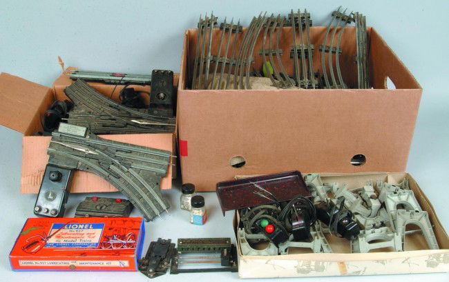 Lionel O Gauge Track and Accessories Lot; 927 Main: Lionel O Gauge Track and Accessories Lot; 927 Maintenance Kit, 022 Switches and Remote Tracks, Die Cast Baggage Cart, Smoke Pellets and numerous pieces of Track. Condition: Fair to good.