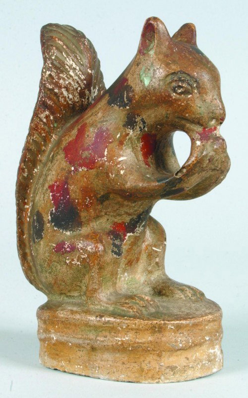 Pennsylvania 19th Century Molded Chalkware Figure : Pennsylvania 19th Century Molded Chalkware Figure of a Squirrel eating a nut. Gilt painted ground with red and black decorative dots. 6 1/2" high. Condition: Good.