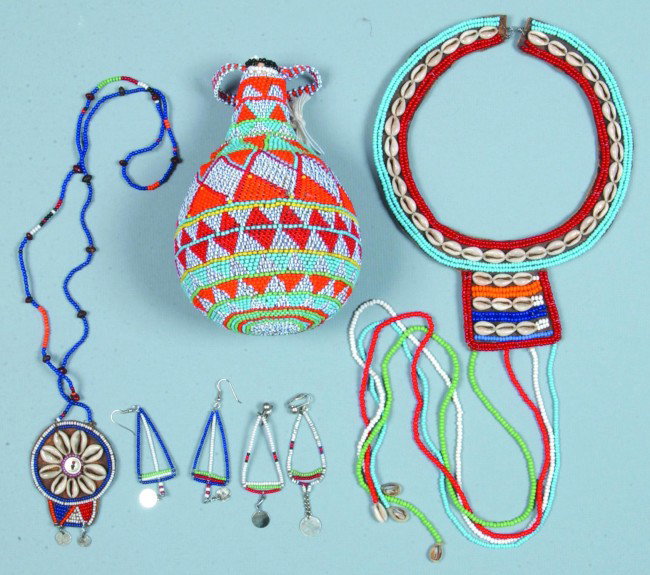 Lot of Maasai Shell and Beadwork Items; Wedding he: Lot of Maasai Shell and Beadwork Items; Wedding headdress, necklace, two various pairs of earrings and a gourd bottle. Condition: Good.