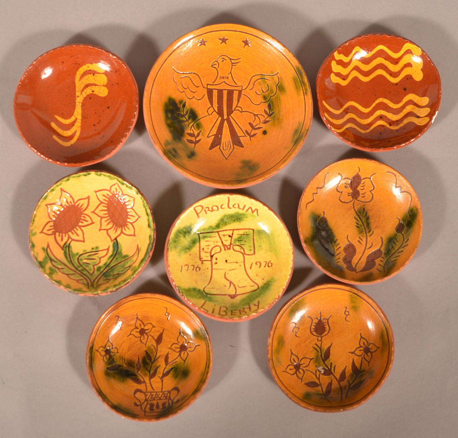 Eight Small Breininger Pottery Plates.