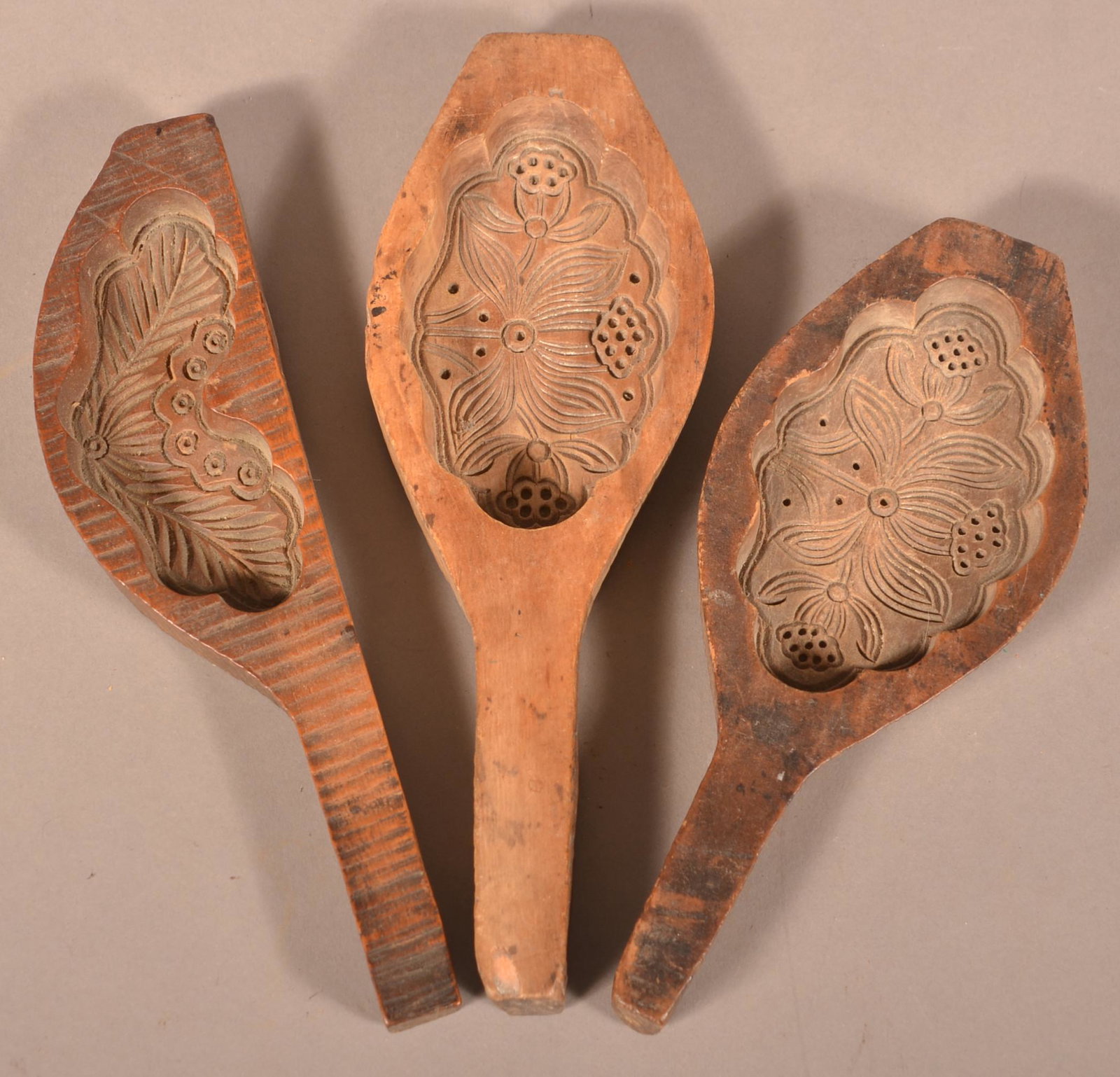 Three Antique European Carved Wood Butter Molds.: Three Antique European Carved Wood Butter Molds. Paddle form with floral and foliate motifs. Largest 10-1/4"l. Condition: Good with use wear.