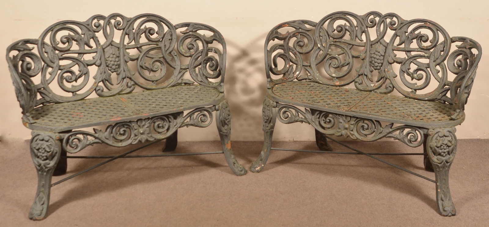 Pair of Victorian Cast Iron Garden Settees.: Pair of Victorian Cast Iron Garden Settees. Grape and scroll pattern. 32"h. x 43"w. x 20"d. Condition: Good with weathering.