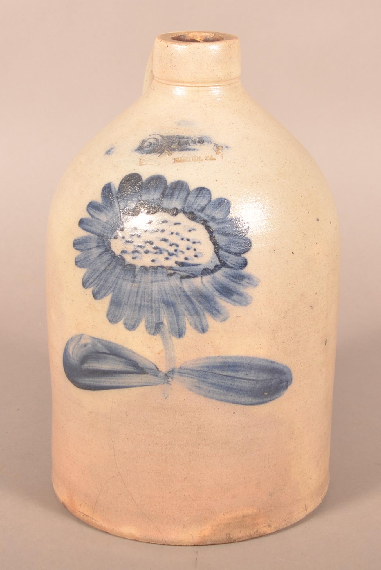 J.M. Harris Sunflower Decorated 2-Gallon Jug.: J.M. Harris, Easton, PA. Sunflower Cobalt Slip Decorated 2-Gallon Stoneware Jug. 13-1/2"h. Condition: Good with a spider line at base. Strong decoration.