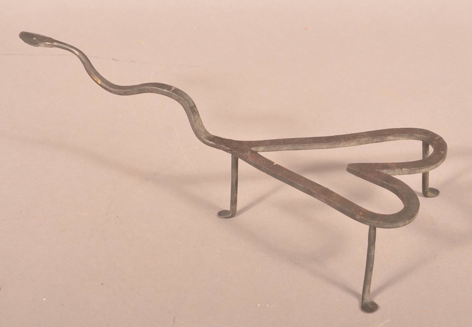 Vintage Wrought Iron Trivet.: Vintage Wrought Iron Trivet. Heart form with snake handle. 16"l. Condition: Good.
