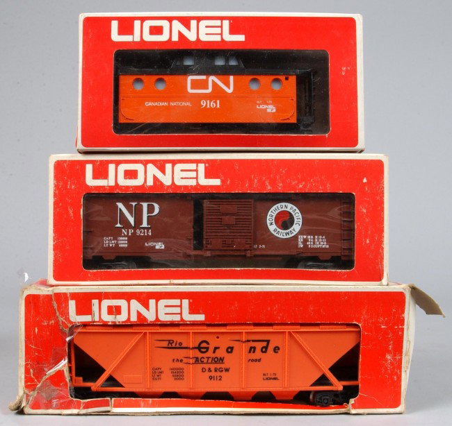 Three Lionel Train Cars, circa 1971, #6-9161 Caboo: Three Lionel Train Cars, circa 1971, #6-9161 Caboose, #6-9112 Covered hopper, overall good condition with boxes showing wear, hopper car box showing excessive wear.