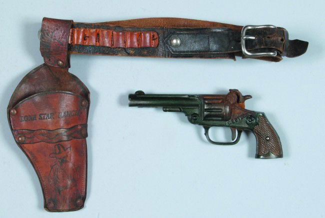 Western Cap Pistol with Leather Belt and Holster,: Western Cap Pistol with Leather Belt and Holster, marked "Lone Star Ranger", 1935-6, cast iron, Mfg. Kenton, condition: gun good w/rust at capper; holster, fair