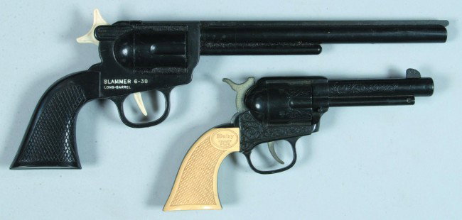 Two Toy Pistols, one Slammer 6-38 long barrel rubb: Two Toy Pistols, one Slammer 6-38 long barrel rubber band gun, plastic, 12-1/2" long, condition: good, one Daisy model 3805 toy, plastic, 8" long, condition: fair