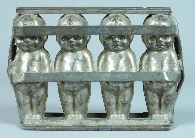 Chocolate Gang Mold marked Heidelberger on base, t: Chocolate Gang Mold marked Heidelberger on base, tinned pressed steel, Four Kewpie dolls, moderate wear to exterior and bright interior, 8" h. x 11-1/2" w..