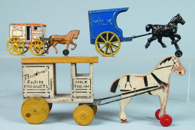 Three various Horse Drawn Milk Wagons; Bordens woo: Three various Horse Drawn Milk Wagons; Bordens wooden Milk & Cream, 10 1/2" long, missing back wheels on horse, unmarked tin and cast iron milk cart, 6 3/4" long, good with wear and a cast lead Grade