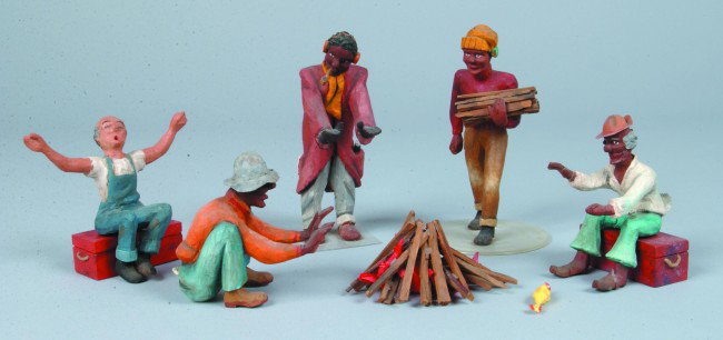 "The Roust-Abouts" Five Wood Carved Figures Gather: "The Roust-Abouts" Five Wood Carved Figures Gathered Around A Camp Fire, attributed to Robert Clark noted miniature circus carver, circa. 1930. 4 1/4" to 6" high. Condition: good.