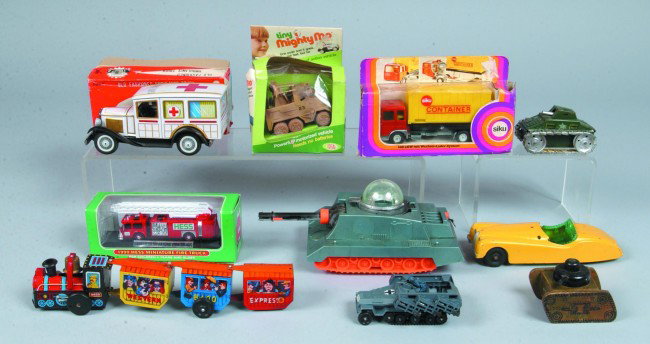 Box lot of Various Tin and Plastic Vehicles includ: Box lot of Various Tin and Plastic Vehicles including tanks, an ambulance a train and more. 3 1/2" to 11" long. Condition: fair to good.