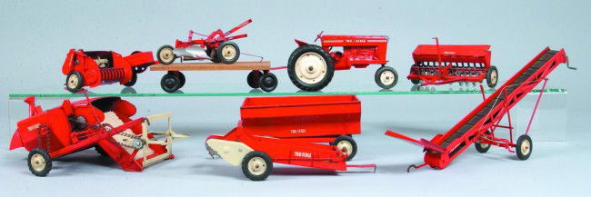 Tru-Scale Row Crop Tractor with Eight Various Impl: Tru-Scale Row Crop Tractor with Eight Various Implements, tractor measures 8" long (missing front grill and exhaust stack). Condition: good with normal scratches and wear.