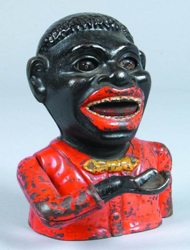 Jolly Negro Mechanical Bank by Shepard Hardware Co: Jolly Negro Mechanical Bank by Shepard Hardware Co., Buffalo, N.Y., patd. March 14. 82, with red shirt, yellow tie, moving hand, tongue and eyes, 7" high. Condition: good with normal scratches and wea
