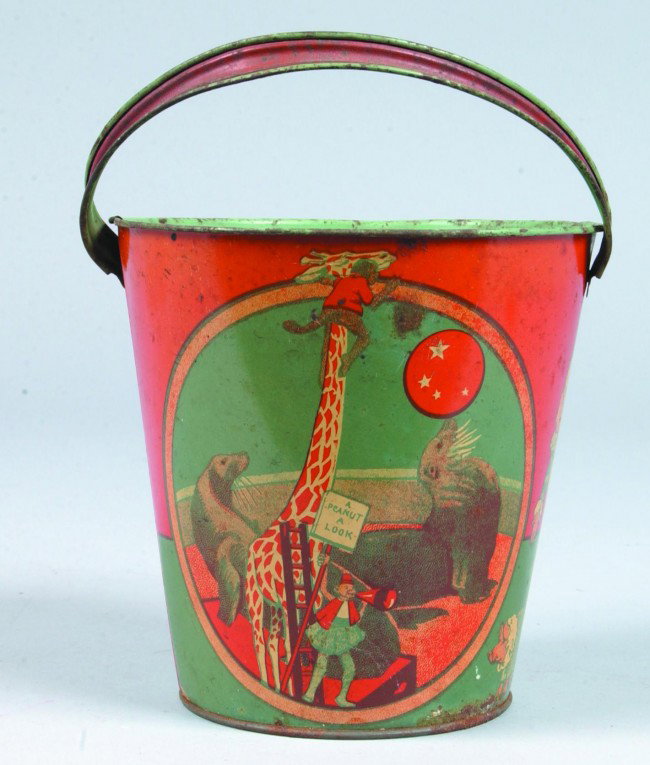 Tin Lithograph Sand Pail, marked made in USA, circ: Tin Lithograph Sand Pail, marked made in USA, circus images, strap handle, 5-3/4" h. x 6" diam., rust spots, light wear.