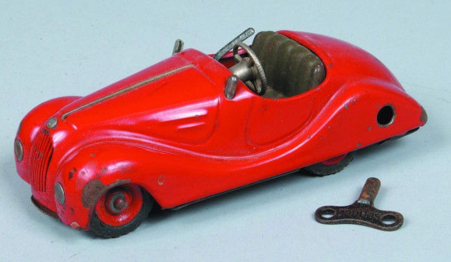 Roadster Wind-up mkd. Schuco Akustico 2002, made i: Roadster Wind-up mkd. Schuco Akustico 2002, made in Germany, painted pressed tin, 5-1/2" l., with key, moderate wear, fair condition.