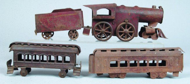 Toy Train Lot, painted stamped steel, engine with : Toy Train Lot, painted stamped steel, engine with tender 17" l. and two passenger cars, paint poor, overall condition poor.