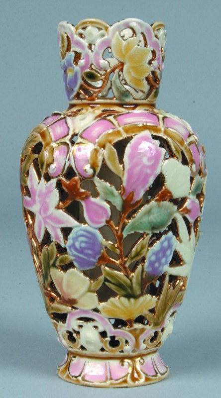 Zsolnay Lusterware Pottery Reticulated Vase with po: Zsolnay Lusterware Pottery Reticulated Vase with polychrome floral and foliate design, marked "MADE IN AUSTRIA HUNGARY ZSOLNAY", 7" high. Condition: good.