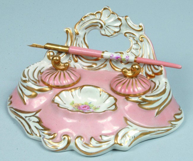 20th Century Porcelain Inkwell Set with gold paint: 20th Century Porcelain Inkwell Set with gold painted highlights and floral transfer sprays and original inserts and matching pen. 3 3/4" high x 7 1/2" wide. Condition: good.