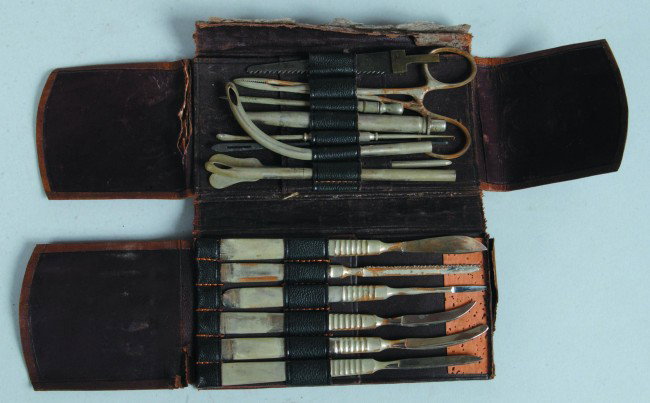 Surgical Pocket Case, 3"w. x 5.5"l. closed; Double: Surgical Pocket Case, 3"w. x 5.5"l. closed; Double folded wallet with flaps in alligator leather; containing 15 instruments, scalpels, forceps, catheters, saws, related etc. Instruments show wear of p