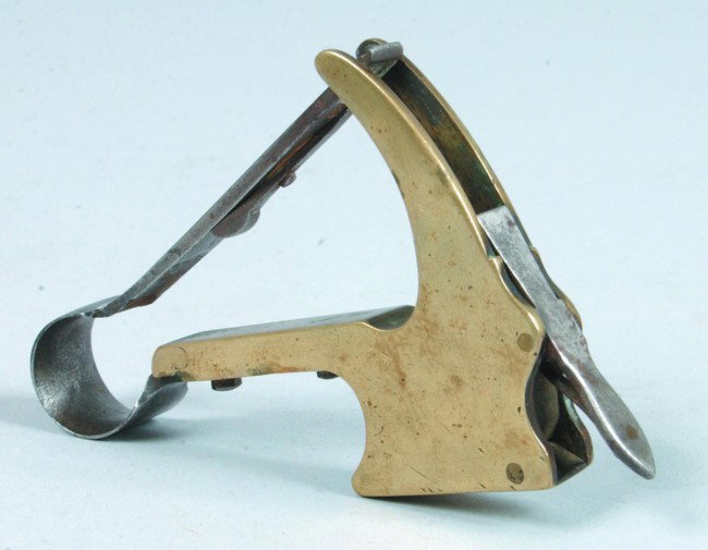 Spring Lancet, 3"w. x 3.5"l.; Large brass 'handled: Spring Lancet, 3"w. x 3.5"l.; Large brass 'handled' body with external trigger, spring, and detachable blade; hinge lidded containment for blade in handle. Lid marked "R. Buchmiller, Lancaster". Appea