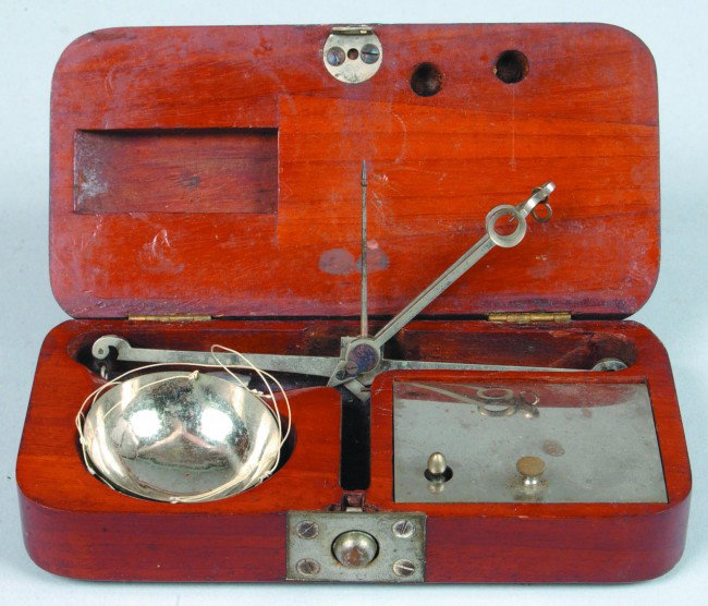 Cased Gold Scales, 2.75"w x 5.5"l.; Steel balance : Cased Gold Scales, 2.75"w x 5.5"l.; Steel balance beam with 2 string suspended 1.5"d. pans and 19 chip weights in a mahogany hinged lid box with spring latch. good Condition
