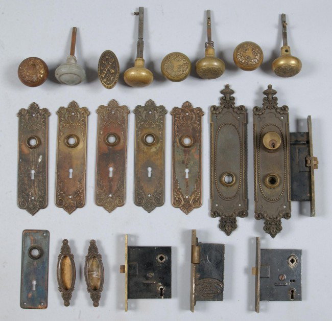 Box Lot of Brass/Bronze Door Hardware; 8 late Vict: Box Lot of Brass/Bronze Door Hardware; 8 late Victorian plates, 4 knob sets, 4 locks, pr. Pocket door handles; locks marked "Corbin". Condition good