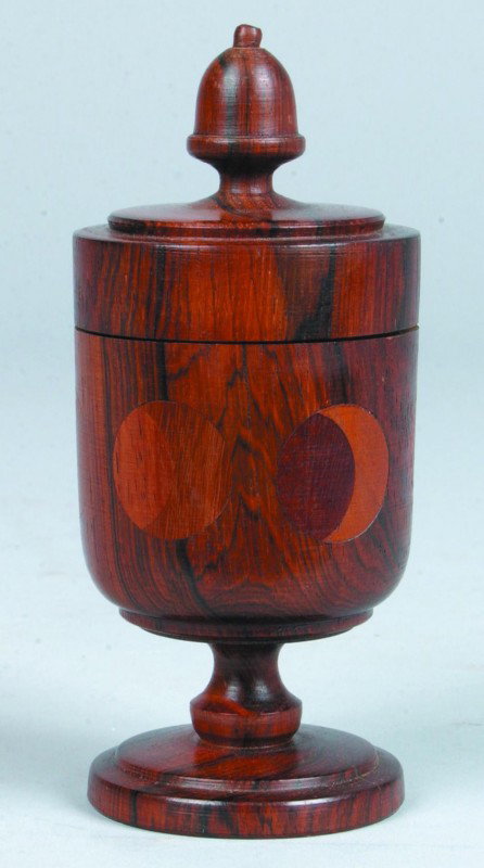 Jacob E. Brubaker Saffron Cup, 2.5"d. x 6"h., turn: Jacob E. Brubaker Saffron Cup, 2.5"d. x 6"h., turned lidded rosewood cup with acorn finial, 6 moon phase medallions inlaid in side. Signed on bottom: "JEB '76". Condition good