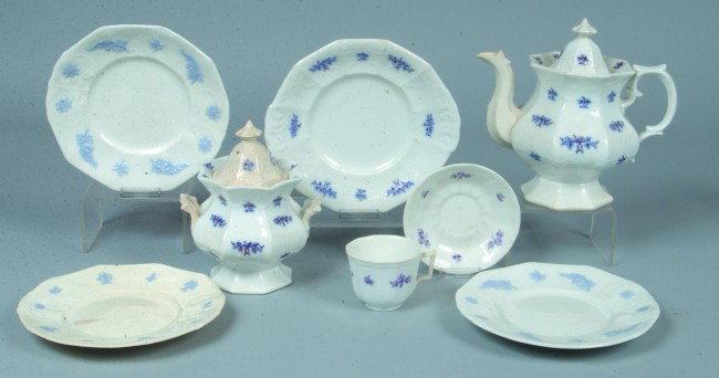 Eight Pieces Paneled White Ironstone; applied blue: Eight Pieces Paneled White Ironstone; applied blue and copper luster to grape mold features; Pot 9"h., Sugar 7 3/4"h., Cup 2 3/4"h., Saucer 5 1/2"d., Cake Plate 9"d., 3 Plates 8 3/4"d. No makers marks