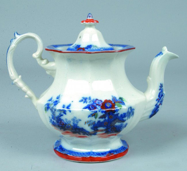 Flow Blue Ironstone Tea Pot, 9"h.; hand painted re: Flow Blue Ironstone Tea Pot, 9"h.; hand painted red, green and gold accents, ten paneled. No marks. Condition: Good