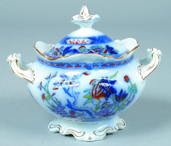 Flow Blue Ironstone Covered Sugar, 6"h.; decorated: Flow Blue Ironstone Covered Sugar, 6"h.; decorated with red, green, purple and gold accents. No marks. Condition: Good