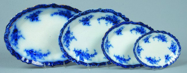 Four Graduated Flow Blue Ironstone Oval Platters,: Four Graduated Flow Blue Ironstone Oval Platters, 10 1/2"l., 12 1/2"l., 15"l., 16 3/4"l.; gold accents, all Touraine design. Marked: Stanley and Henry Alcock Pottery. Condition: Two larger platters ea
