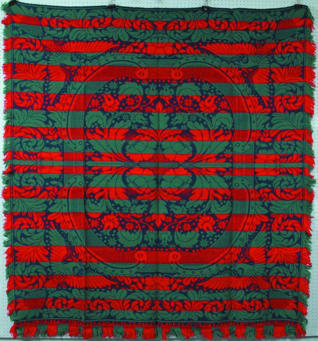 Coverlet, 79" x 84"; red and grayblue on blue, cen: Coverlet, 79" x 84"; red and grayblue on blue, central oblong medallion of leaves, flowers and stars with spred eagles in corners, scrolled folate border with pineapples in corners. Signed on end bord