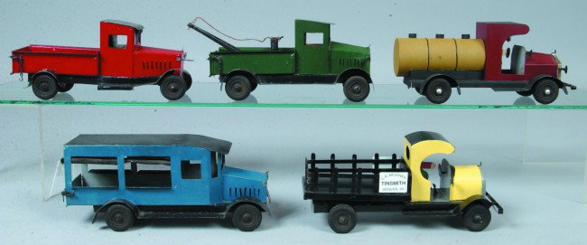 Five Handmade and Painted Steel Toy Trucks, 10" to: Five Handmade and Painted Steel Toy Trucks, 10" to 11"l.; painted tinned sheet steel, rubber wheels. Marked: "C.R. Messner, Denver, PA.", tank truck, stake truck, tow truck, pick-up truck and a sedan 