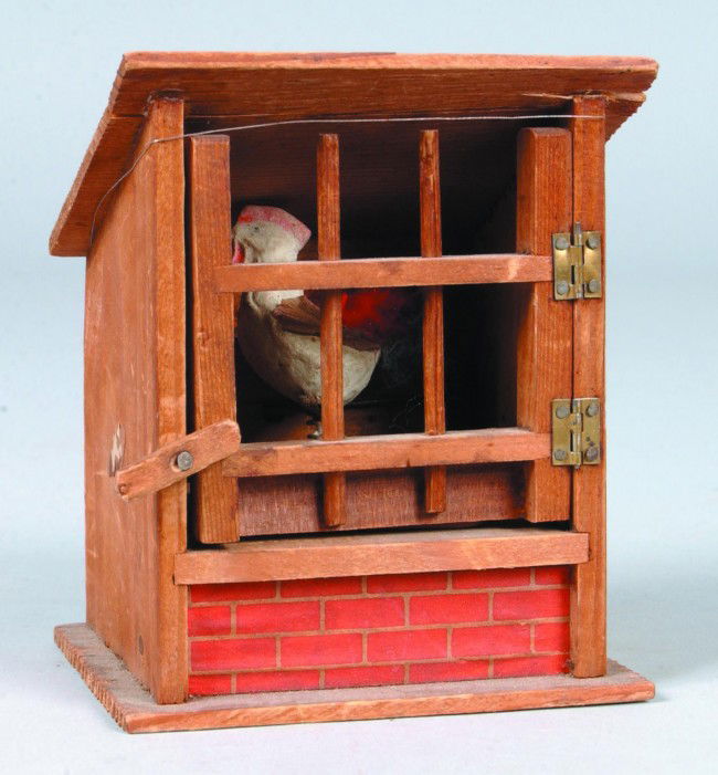 Chicken in Coop Squeek Toy, 4"w. x 4 1/4"h.; plast: Chicken in Coop Squeek Toy, 4"w. x 4 1/4"h.; plaster rooster on swivel, wood coop with printed paper roof. No makers marks. Condition: bellows detached, detatched spring, loss of roof paper and crack.